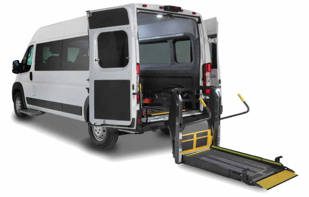 White Ram ProMaster NEMT van with yellow hydraulic wheelchair lift deployed