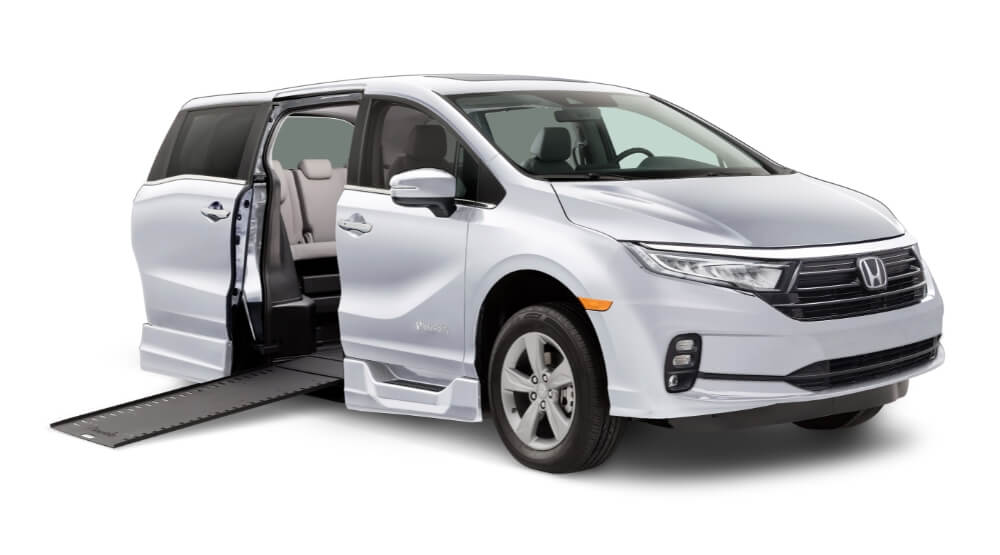 White 2023 Honda Odyssey BraunAbility wheelchair accessible minivan with side entry ramp deployed